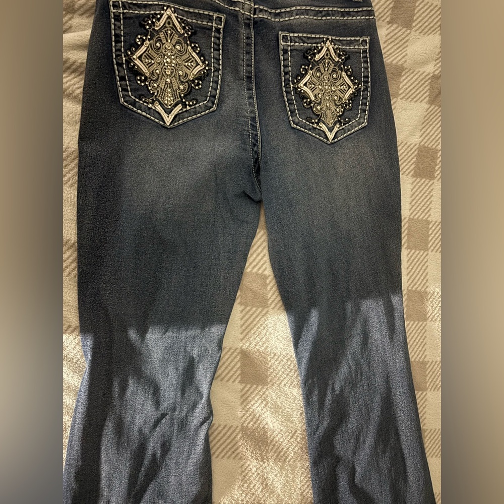 Flared jeans with back pocket rhinestones.